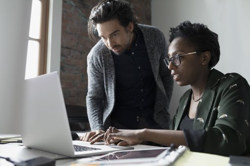 two people looking at the laptop