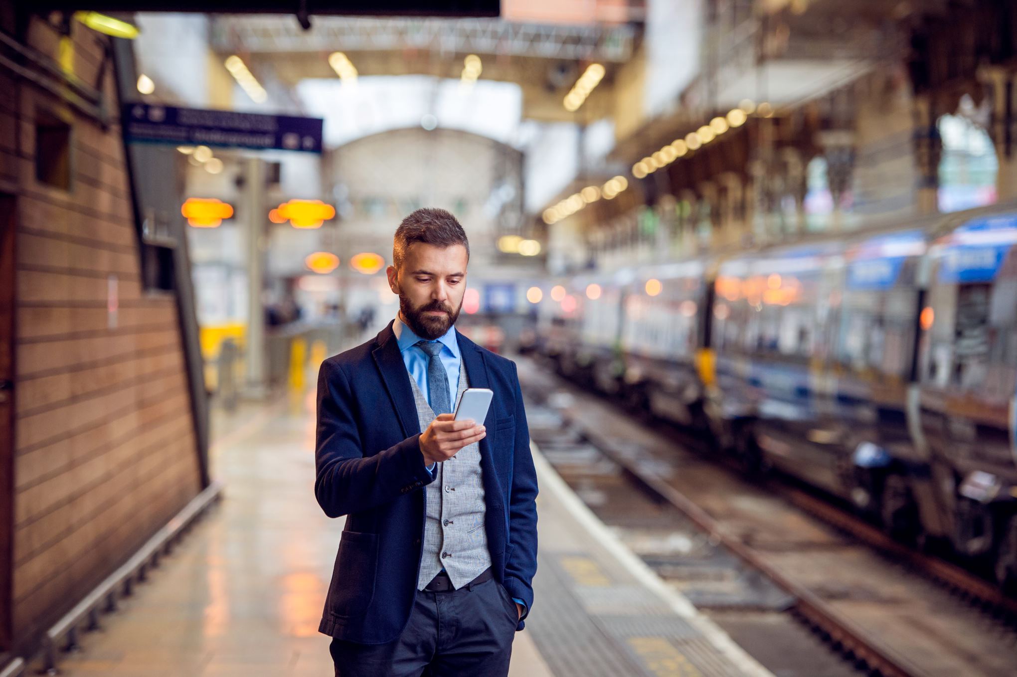 person checking his phone at the subway