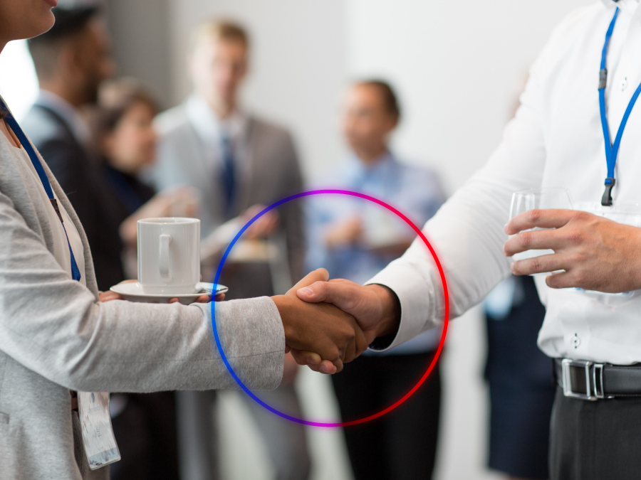 Two professionals shaking hands in an Expo meeting room