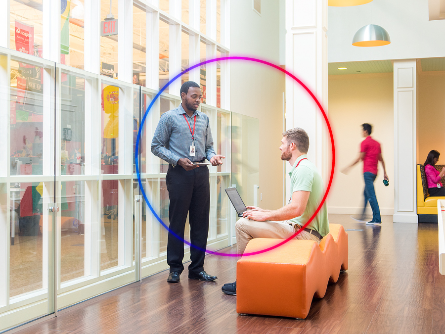 Two Rackers discussing a project in a common area of the company headquarters