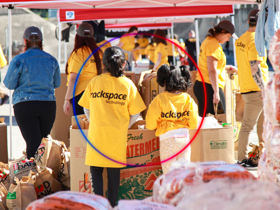 Rack Gives Back volunteers handing out food donations at our annual Thanksgiving food drive