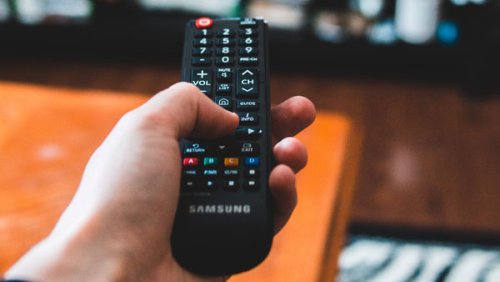 Hand holding a Samsung remote control